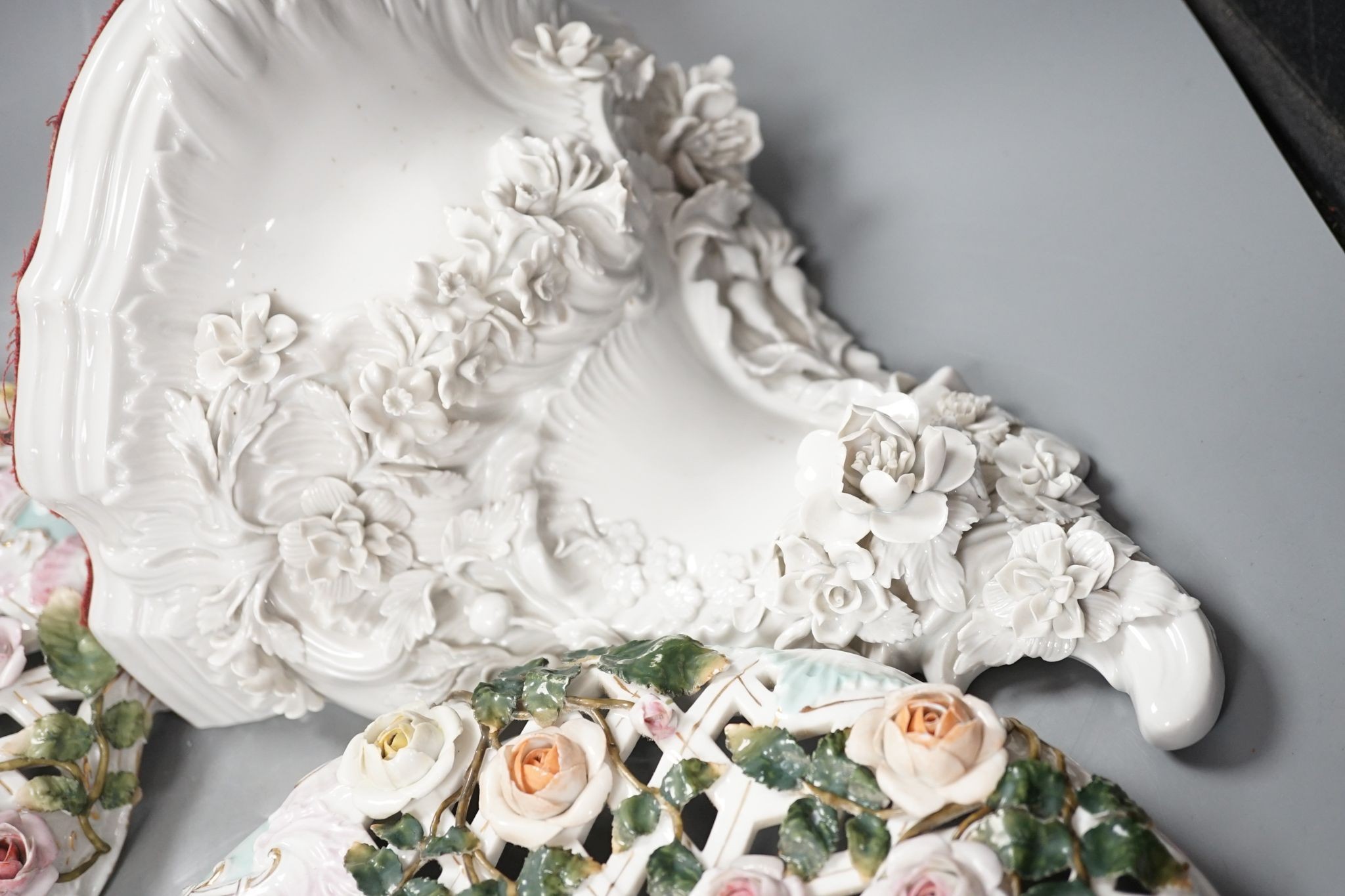 Two Sitzendorf porcelain ceiling shades, a similar wall bracket and a Dresden white glazed wall bracket, shades 30cm diameter